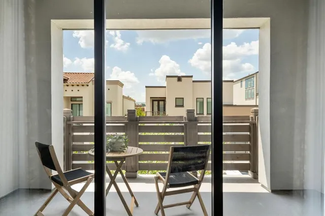 a view of a balcony with chairs