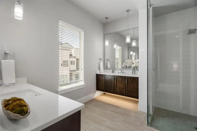 a spacious bathroom with a sink a mirror and a shower