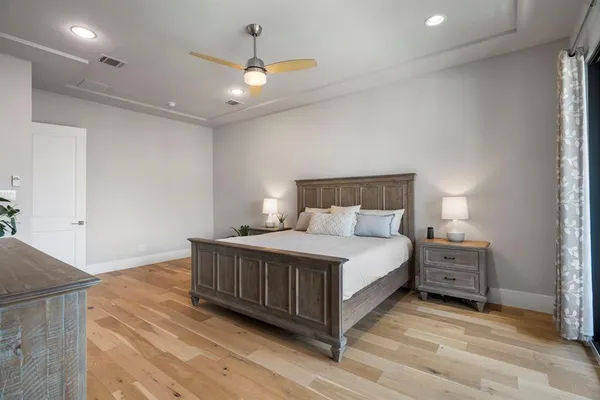 a bedroom with a bed and a chandelier