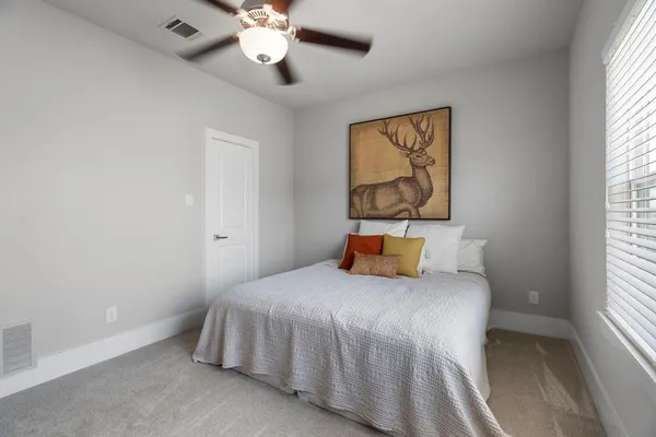 a bedroom with a bed and a large window