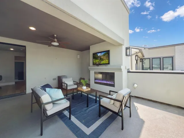 a living room with furniture a fireplace and a flat screen tv
