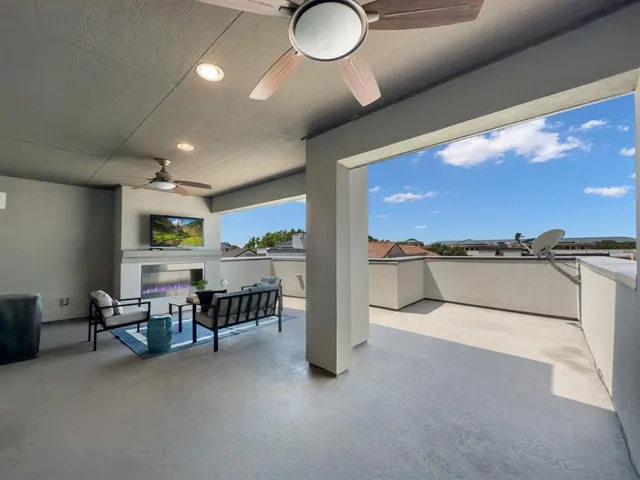 a view of a livingroom with furniture and a floor to ceiling window