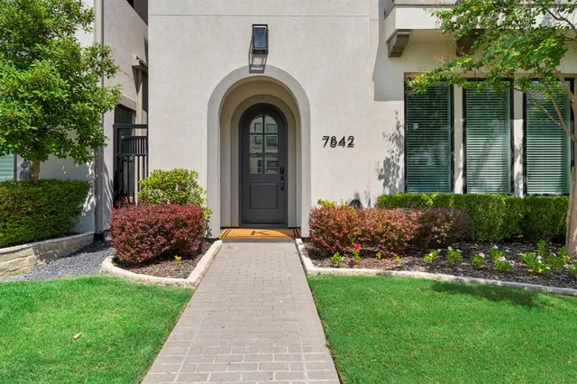 a front view of a house with a garden