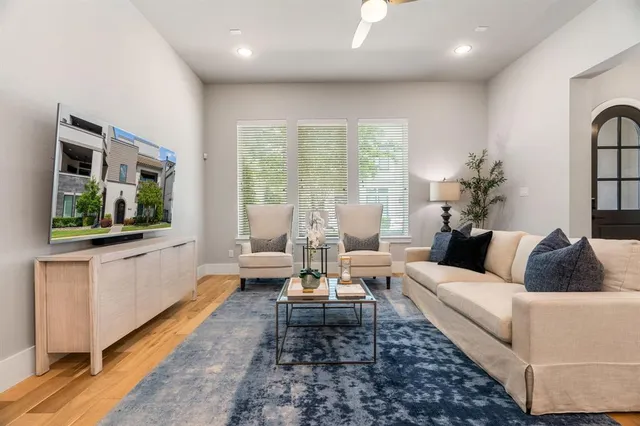 a living room with furniture fireplace and a large window