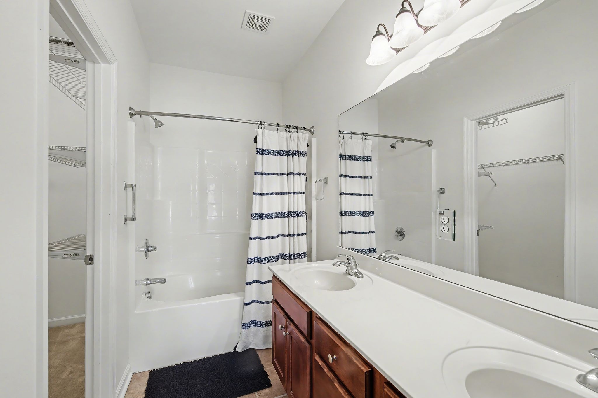 2521 Pennington Bend Road, Unit 211 Nashville, TN 37214 - Photo 13 of 21 a bathroom with a bathtub a sink and a large mirror