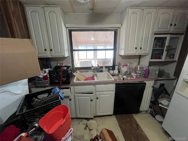 a kitchen with sink a stove and cabinets