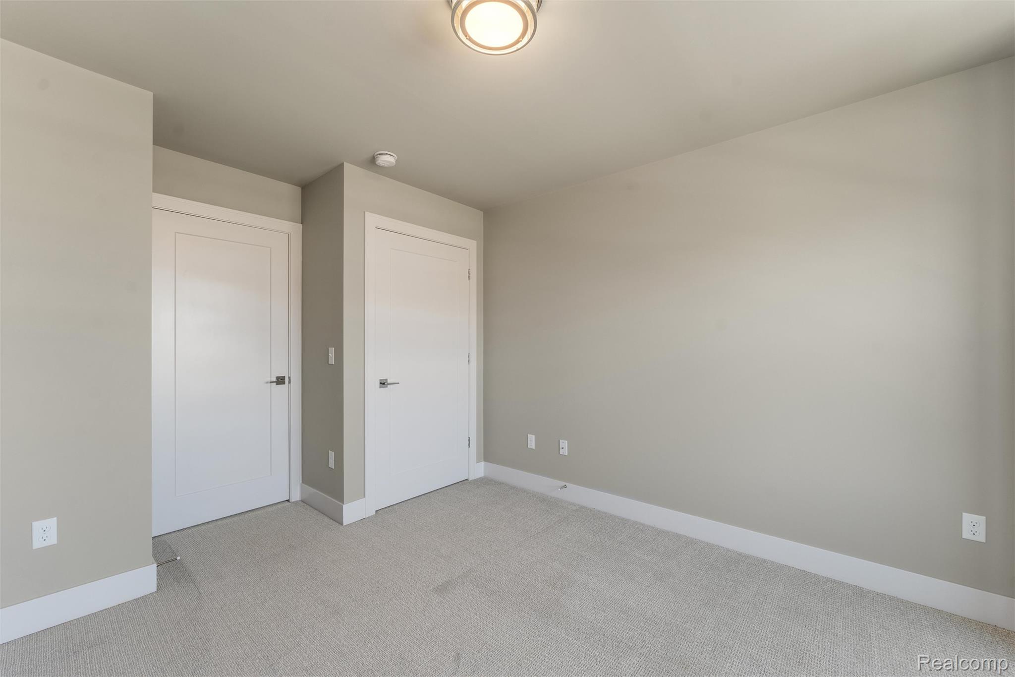 1040 Lamb Road, Unit # 5 Troy, MI 48085 - Photo 11 of 30 Unfurnished bedroom featuring light carpet and baseboards