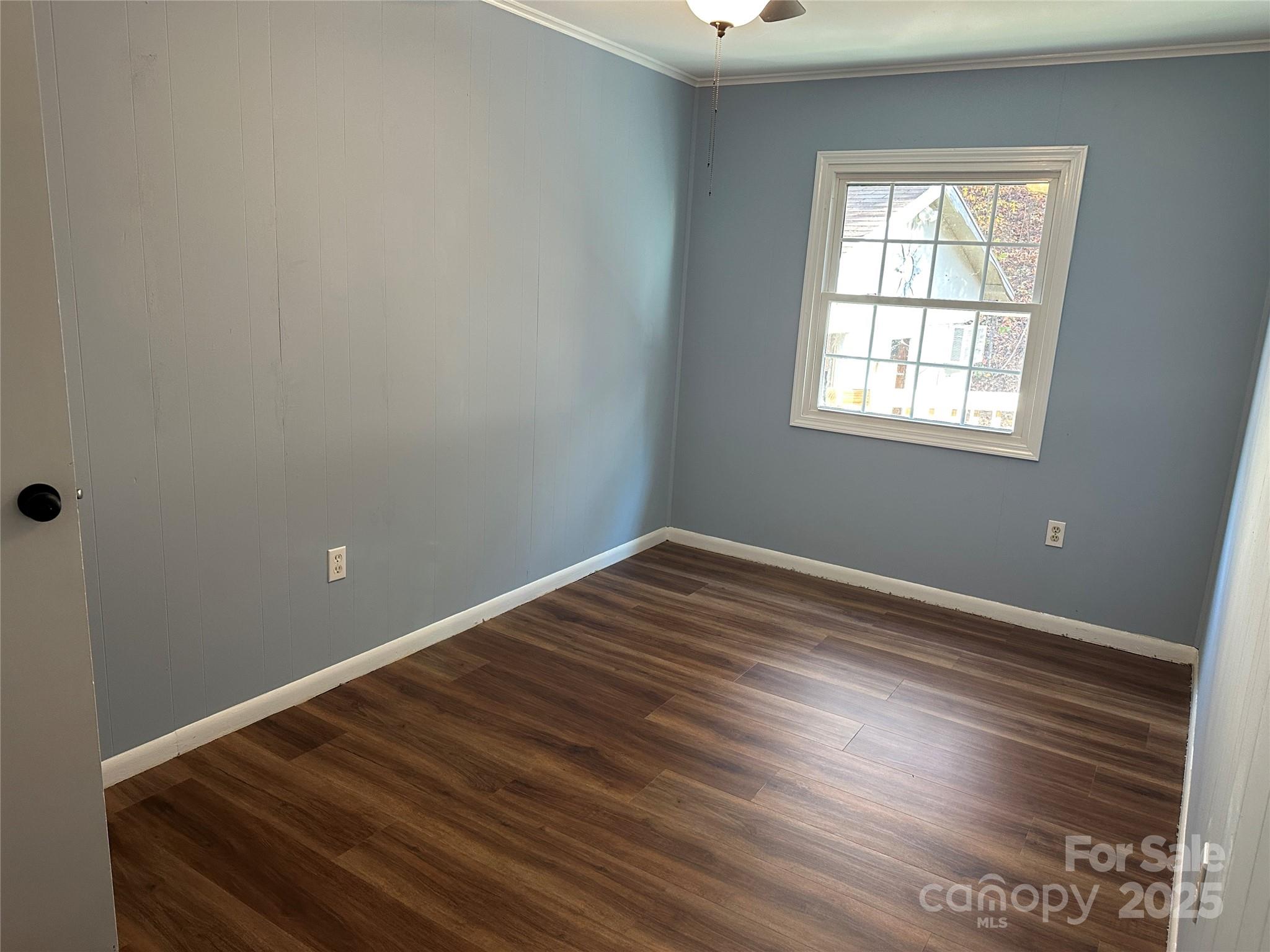 488 John Swofford Road Nebo, NC 28761 - Photo 13 of 18 an empty room with wooden floor and windows