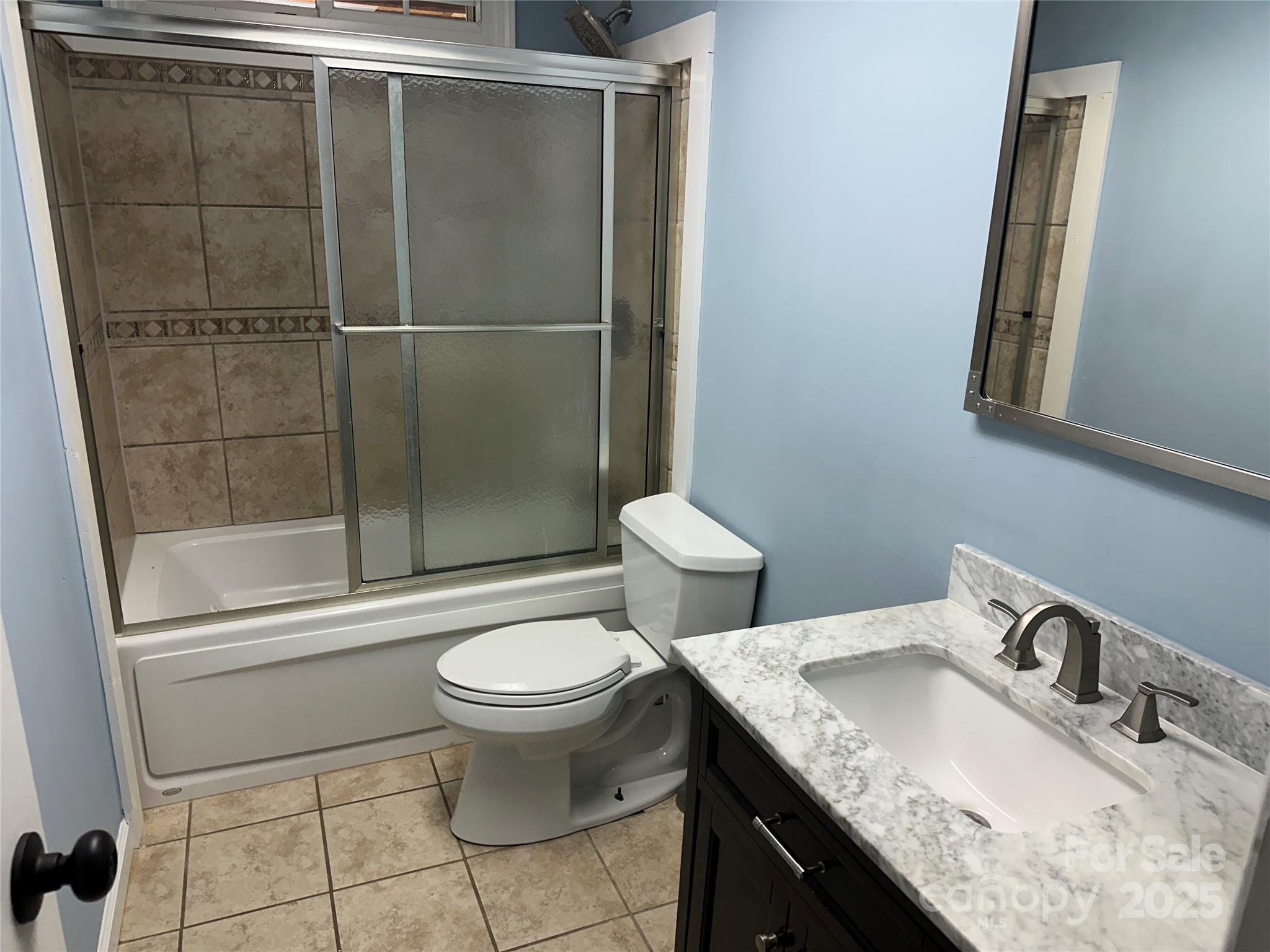 488 John Swofford Road Nebo, NC 28761 - Photo 15 of 18 a bathroom with a granite countertop sink toilet and shower