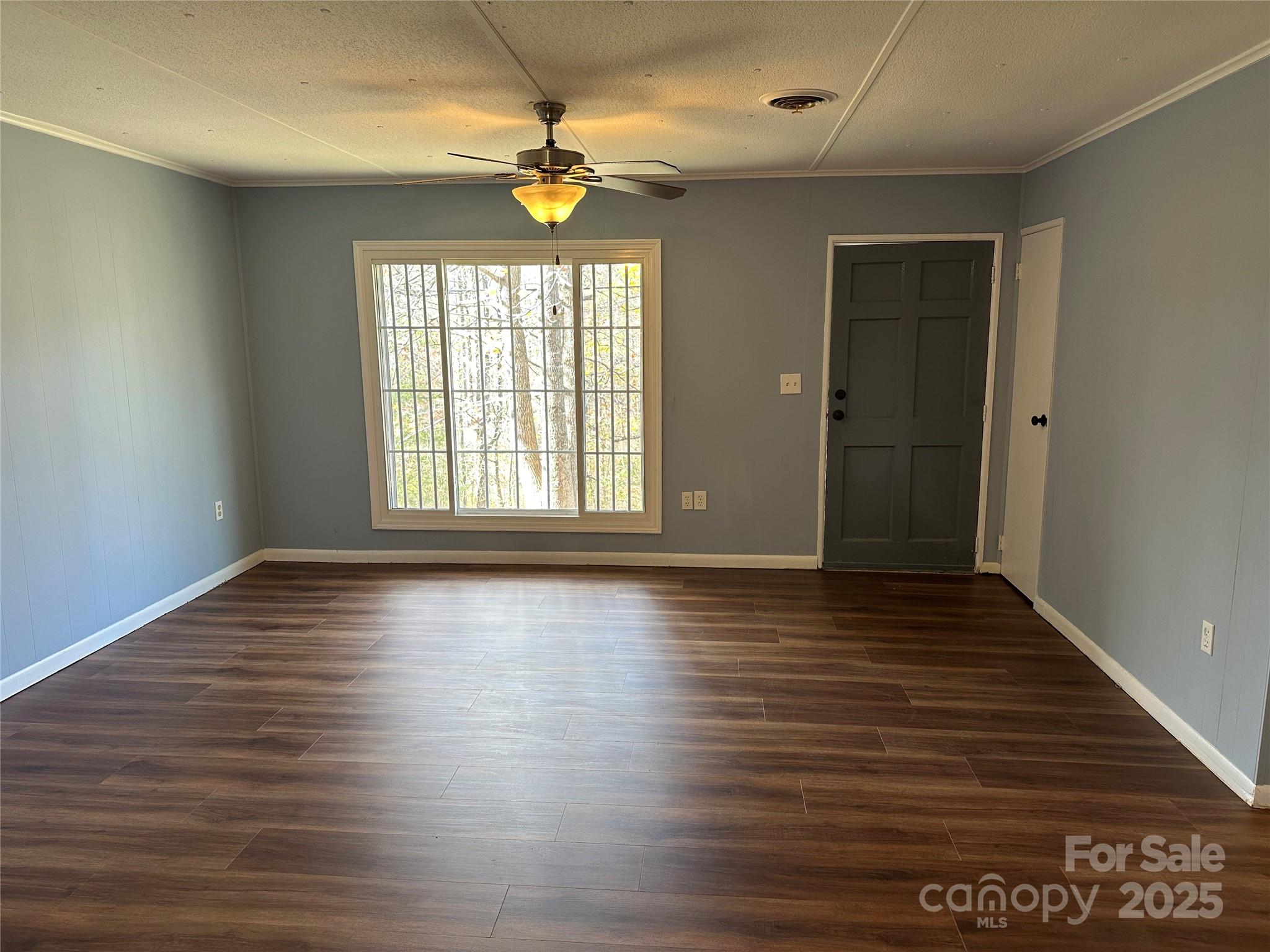 488 John Swofford Road Nebo, NC 28761 - Photo 3 of 18 an empty room with wooden floor and windows