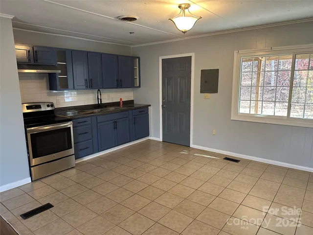 a large kitchen with cabinets and stainless steel appliances