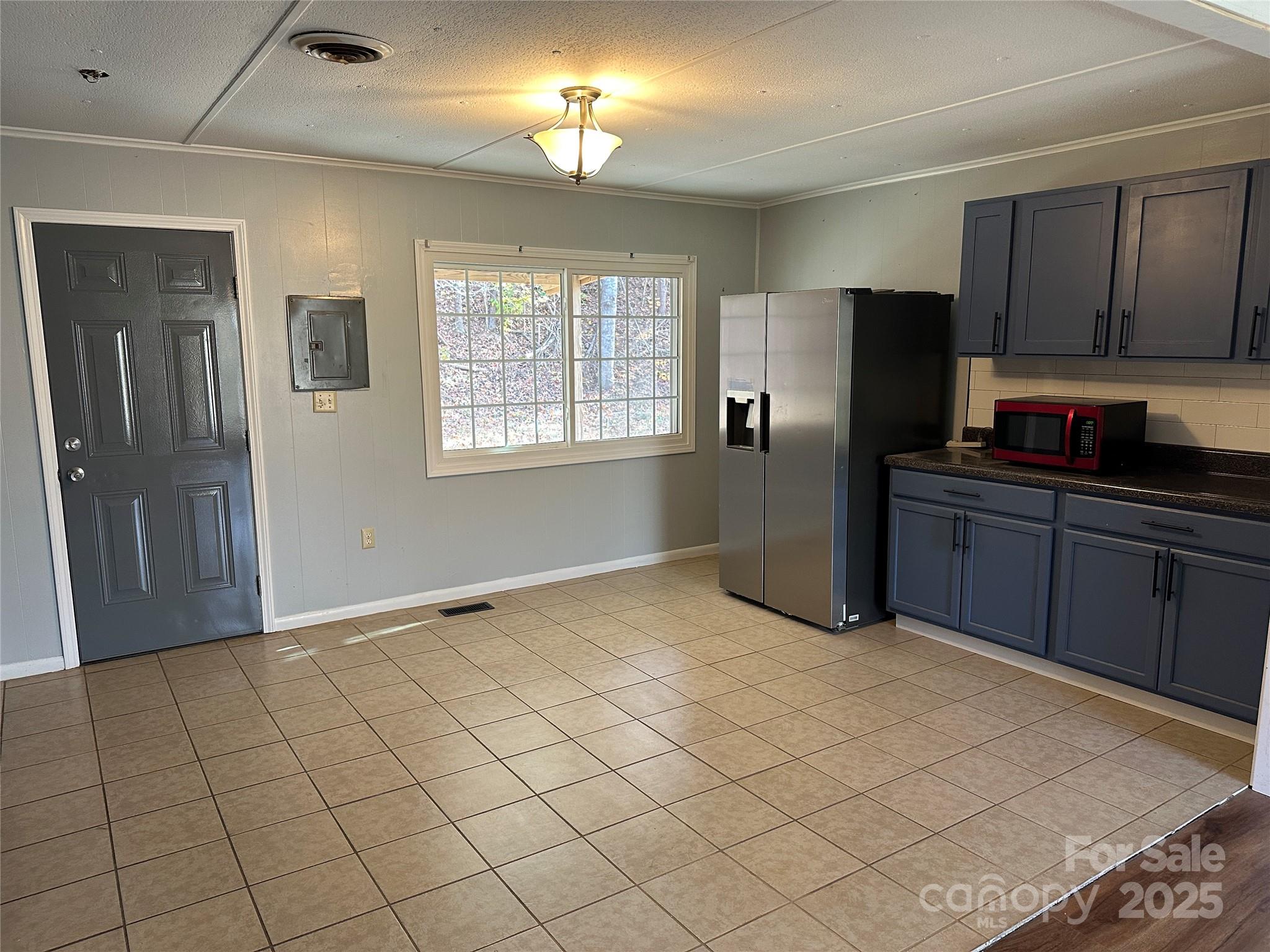 488 John Swofford Road Nebo, NC 28761 - Photo 6 of 18 a kitchen with stainless steel appliances granite countertop a refrigerator a sink dishwasher and wooden cabinets