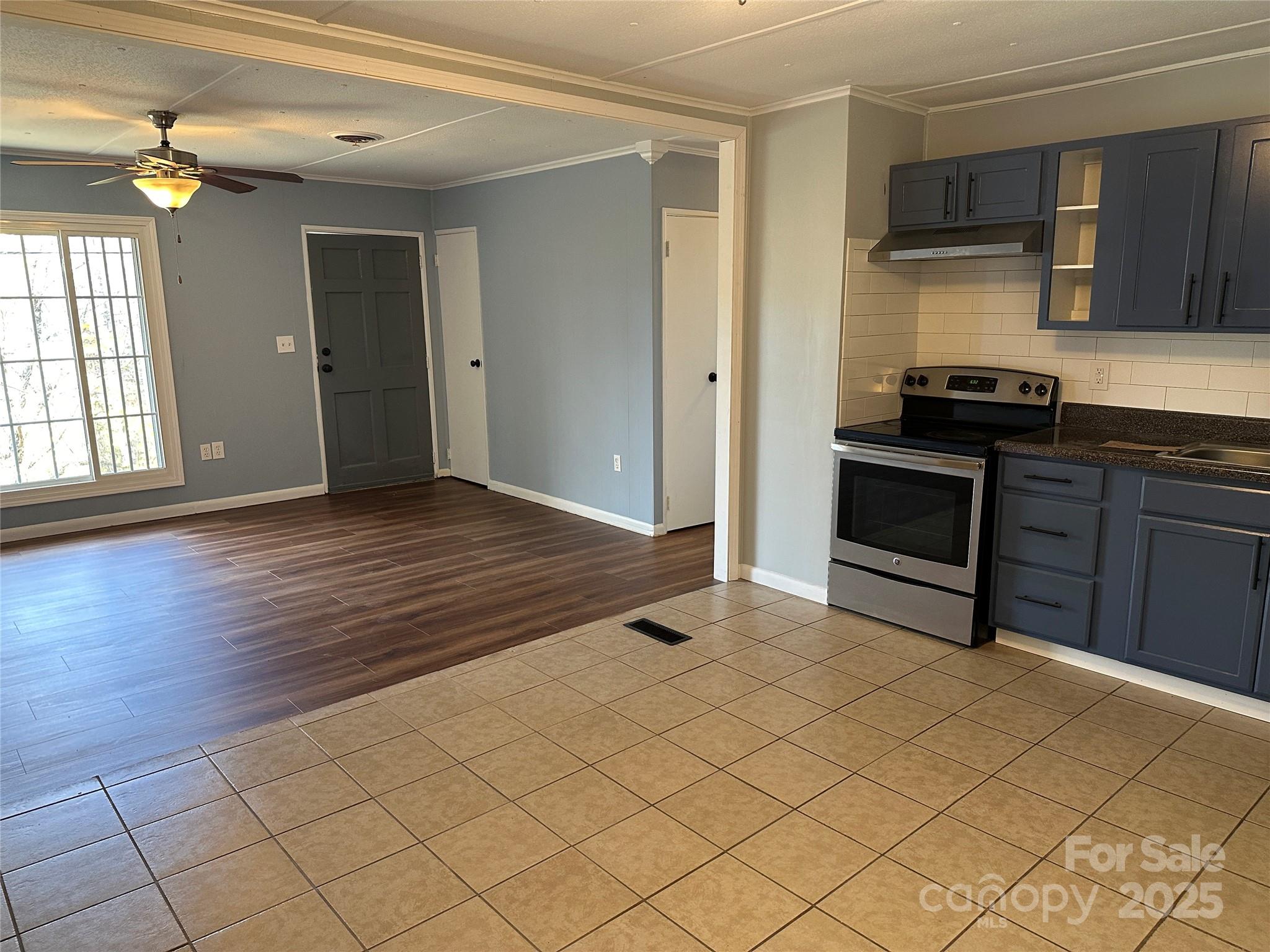 488 John Swofford Road Nebo, NC 28761 - Photo 8 of 18 a view of a kitchen with wooden floor and cabinets