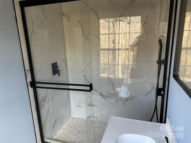 a bathroom with a shower and a window