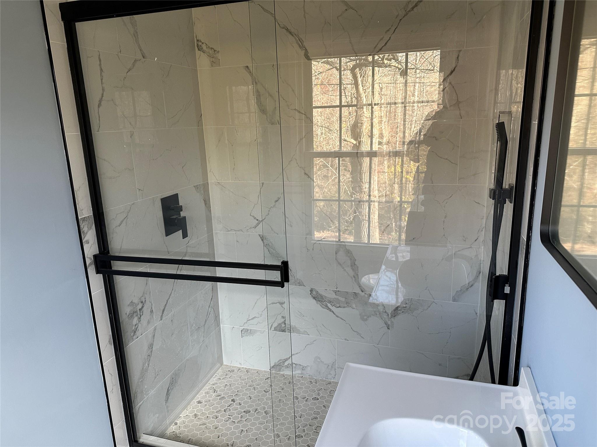 488 John Swofford Road Nebo, NC 28761 - Photo 9 of 18 a bathroom with a shower and a window