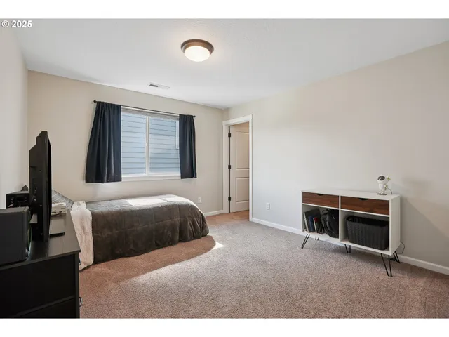 a bedroom with a bed and a desk