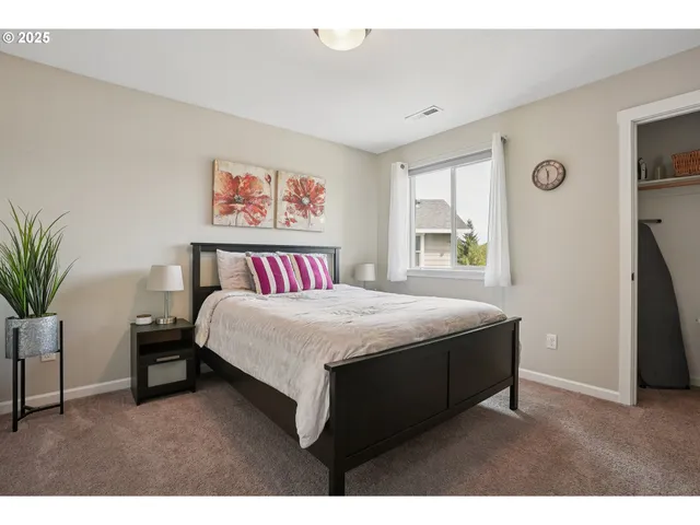 a spacious bedroom with a bed and a window