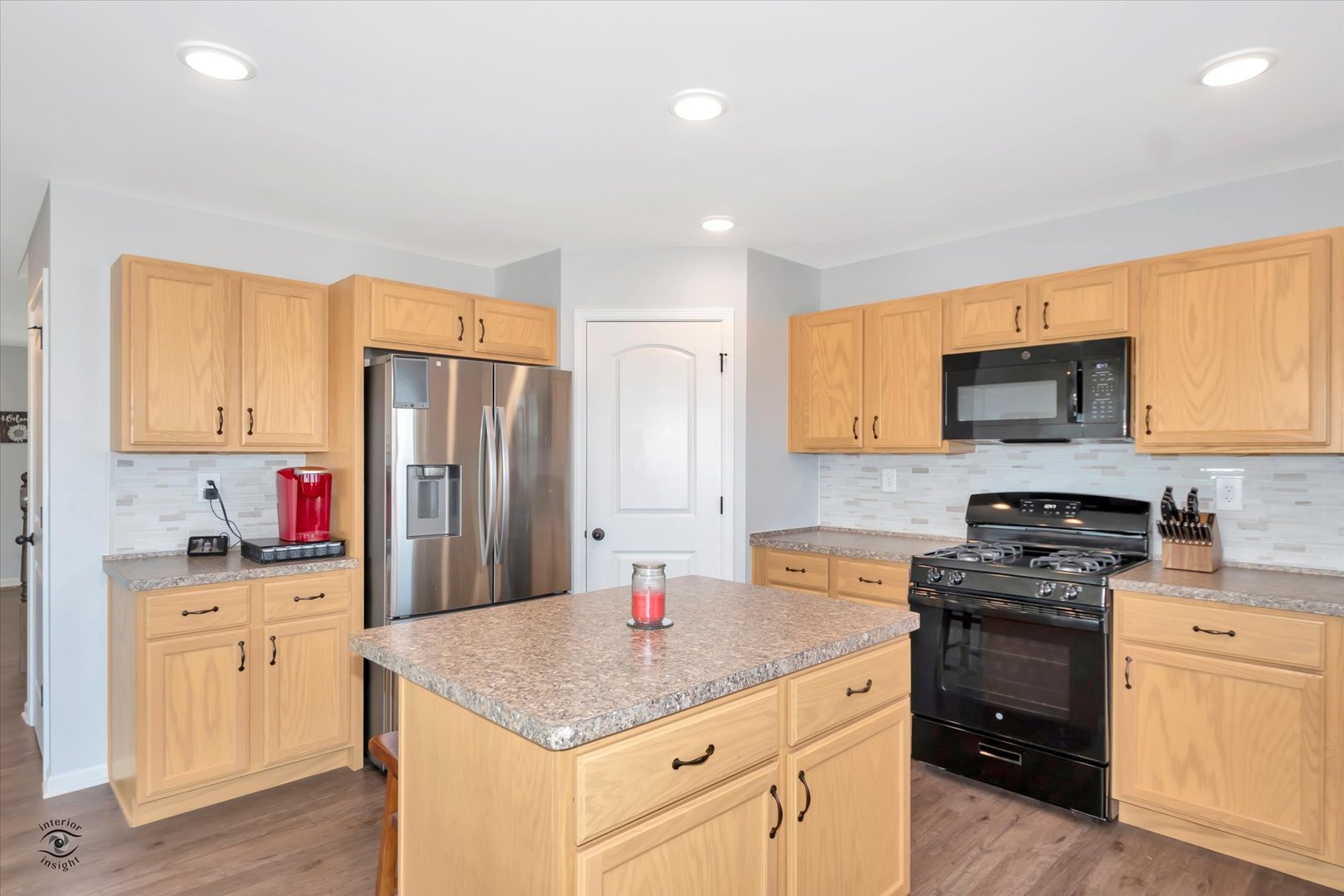 1721 Eagle Ct. Morris, IL 60450 - Photo 6 of 27 a kitchen with a sink a stove a refrigerator a center island and cabinets