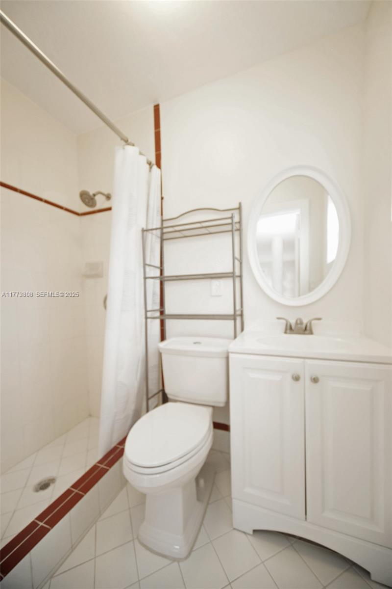 621 Hudson Road West Palm Beach, FL 33405 - Photo 11 of 27 a white toilet sitting next to a bathroom sink