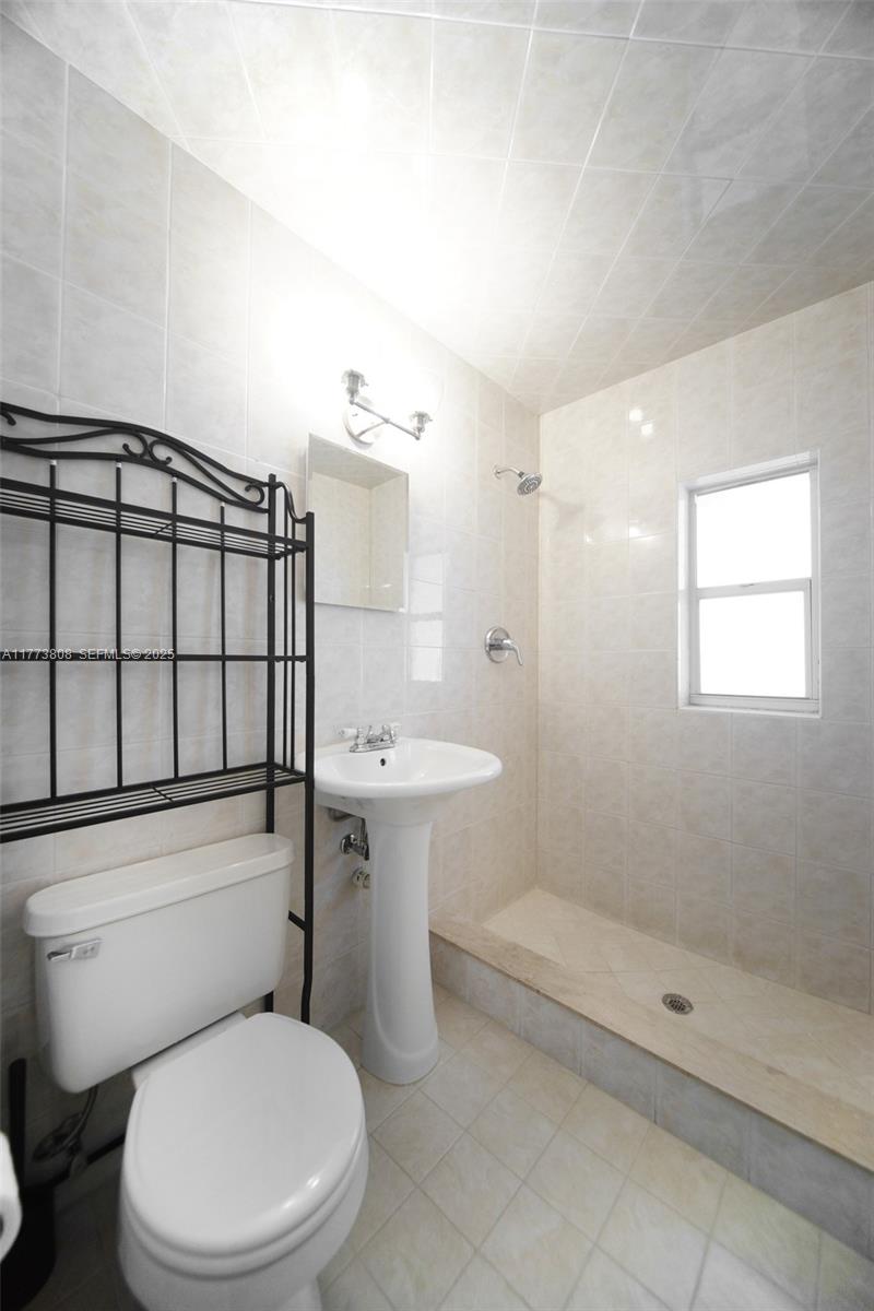 621 Hudson Road West Palm Beach, FL 33405 - Photo 12 of 27 a bathroom with a toilet a sink and shower