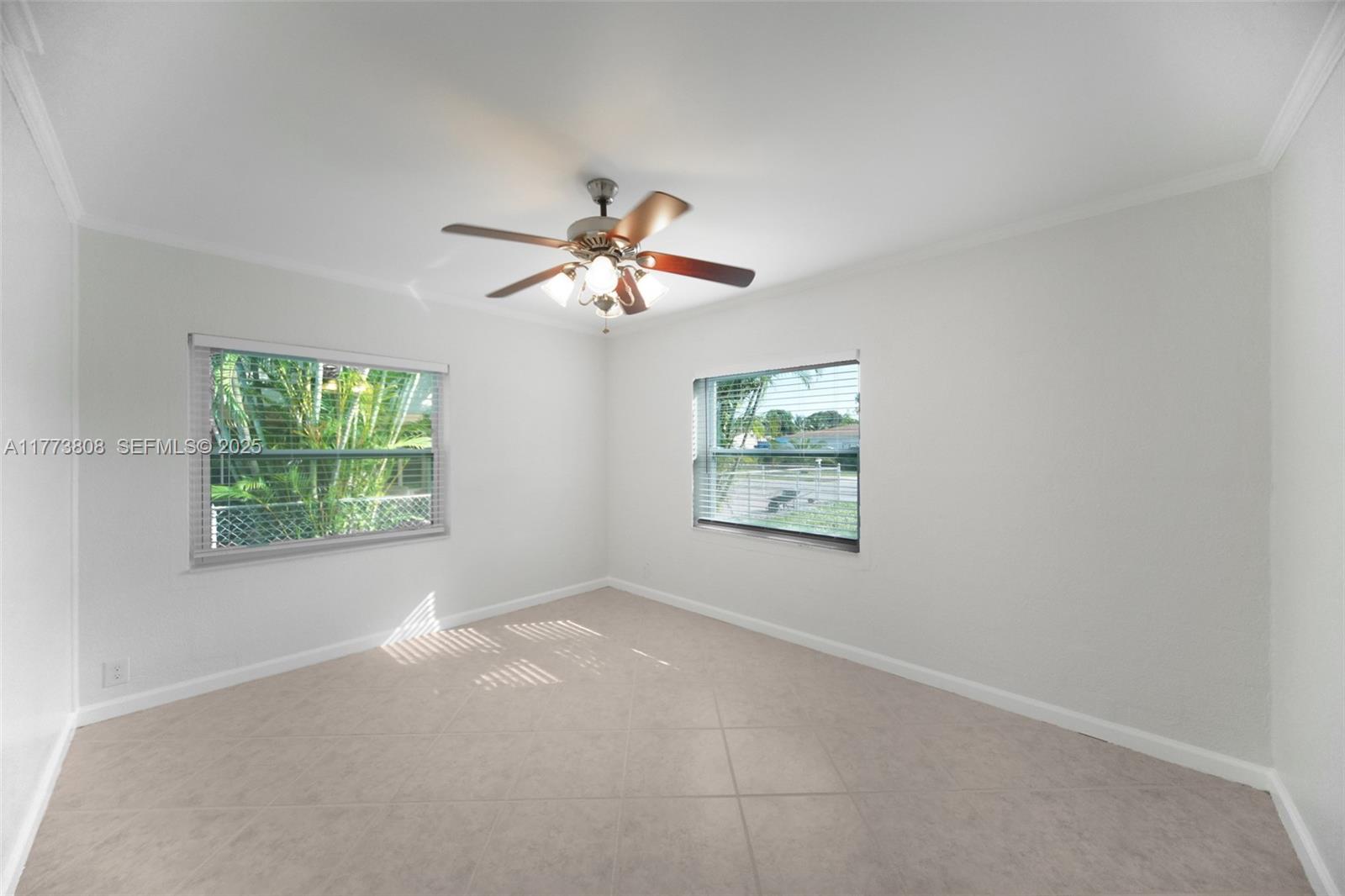 621 Hudson Road West Palm Beach, FL 33405 - Photo 14 of 27 an empty room with windows and fan