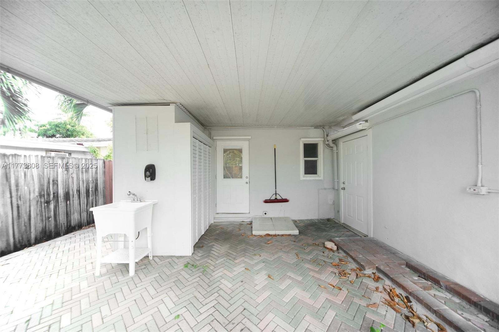 621 Hudson Road West Palm Beach, FL 33405 - Photo 15 of 27 a view of a patio with table and chairs near a yard