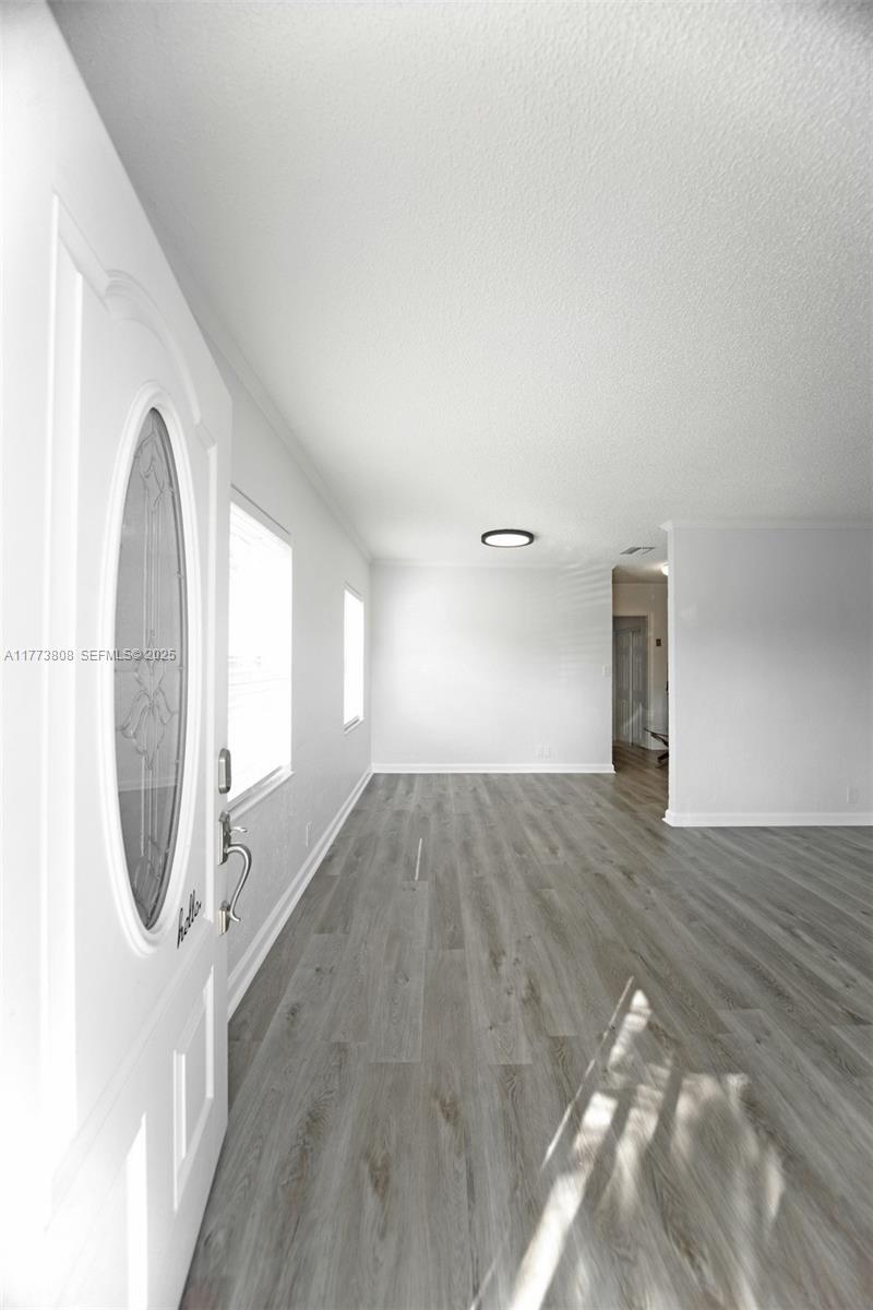 621 Hudson Road West Palm Beach, FL 33405 - Photo 3 of 27 a view of a livingroom with wooden floor and staircase