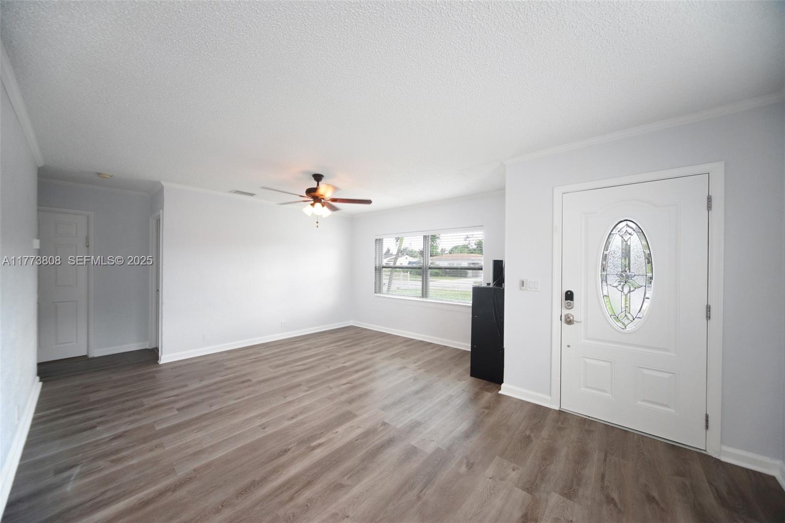 621 Hudson Road West Palm Beach, FL 33405 - Photo 5 of 27 an empty room with wooden floor and windows