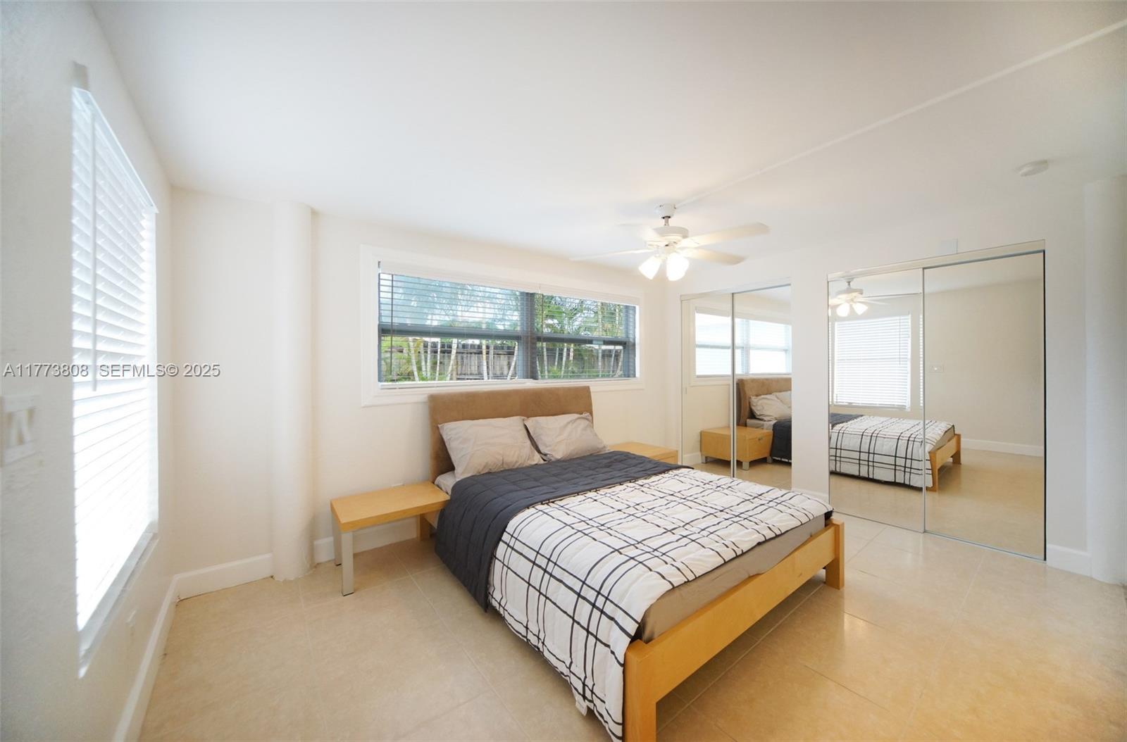 621 Hudson Road West Palm Beach, FL 33405 - Photo 8 of 27 a bedroom with a bed and a chandelier