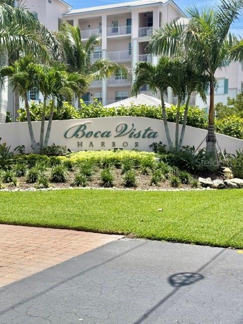 13413 Gasparilla Road, Unit 304 Placida, FL 33946 - Photo 2 of 28 a view of a garden with a bench and trees