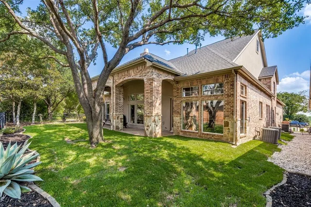 a view of a porch with chairs and a yard