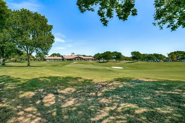 a view of a lake with houses in the back