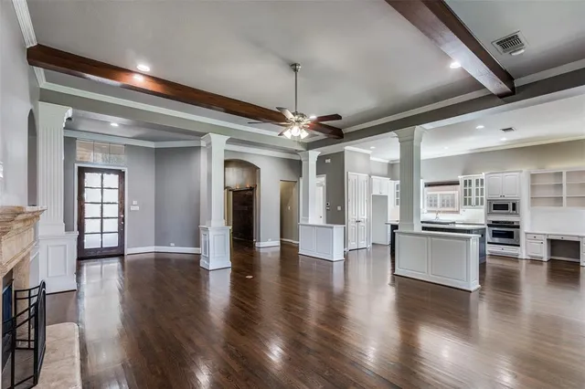 a view of a hallway with wooden floor and a kitchen