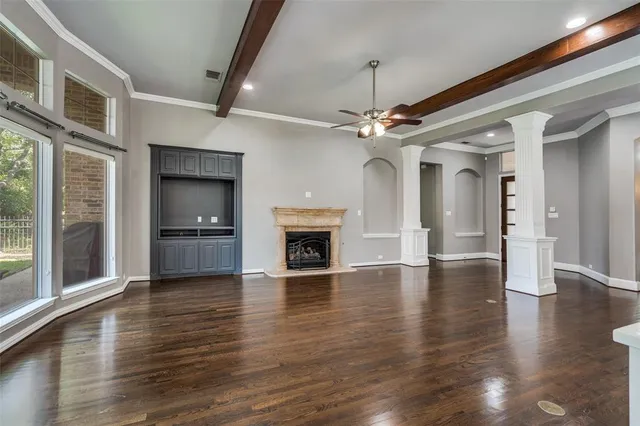 a view of a livingroom with a fireplace wooden floor and fire place