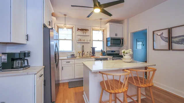 a kitchen with a table chairs refrigerator and cabinets