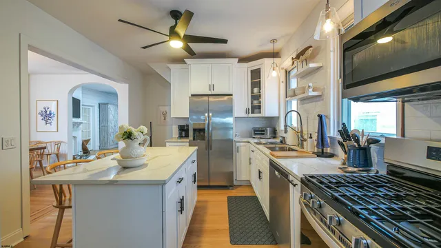 a kitchen with a stove a sink and a refrigerator