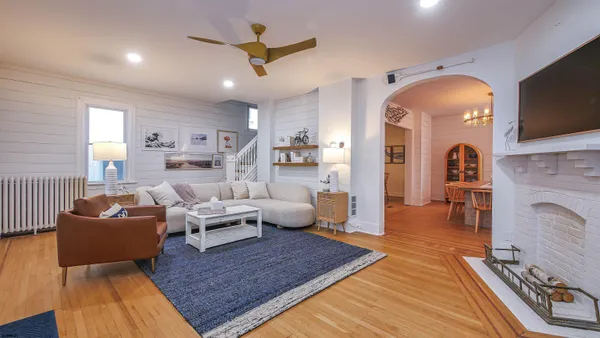 a living room with fireplace furniture and a flat screen tv