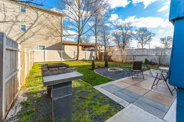 a kitchen with granite countertop a refrigerator and a stove top oven