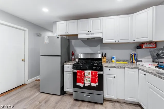 a view of a dining room with furniture and a flat screen tv