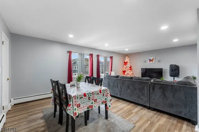 a living room with furniture and a painting on the wall