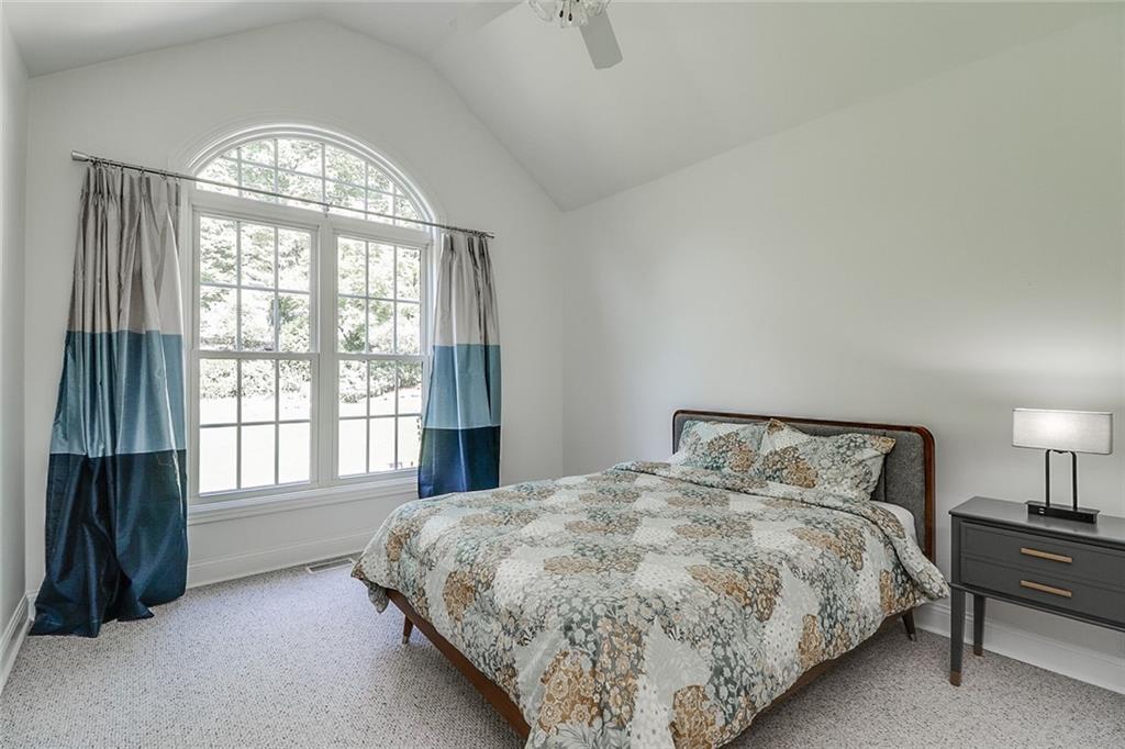 6150 Six Mile Cove Road Cumming, GA 30041 - Photo 11 of 27 a bedroom with a bed and a large window
