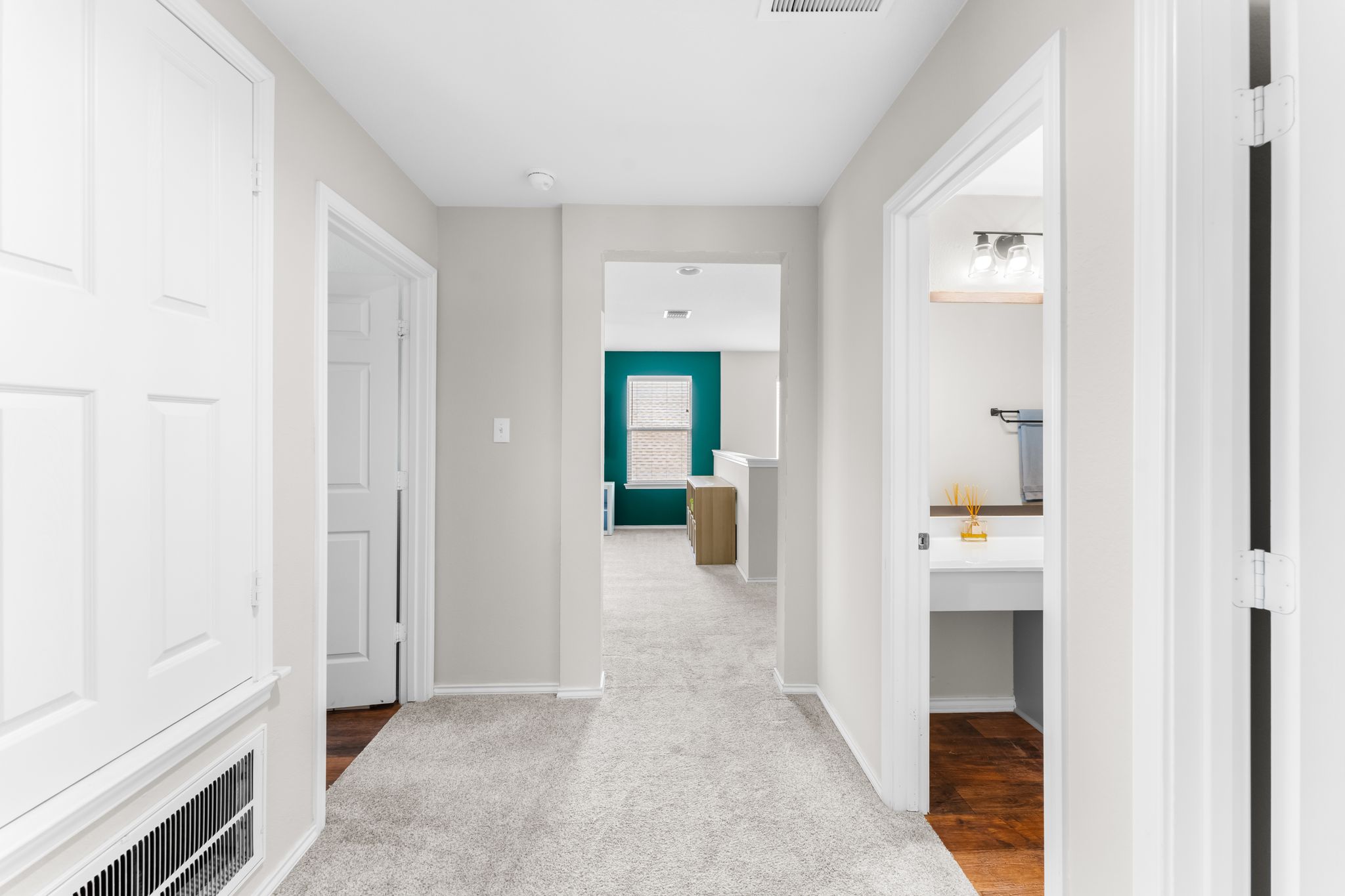 1133 Yellow Iris Road Leander, TX 78641 - Photo 21 of 37 Light grey walls accenting a carpeted hall