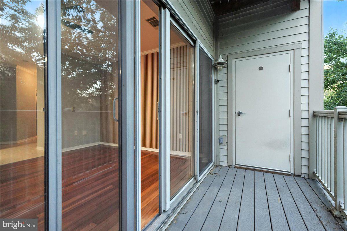 8045 Newell Street, Unit 301 Silver Spring, MD 20910 - Photo 15 of 19 a view of a wooden door and wooden floor