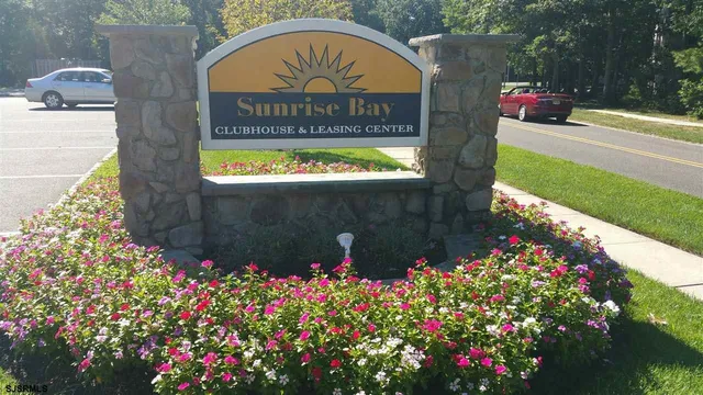 a sign that is sitting in front of flowers