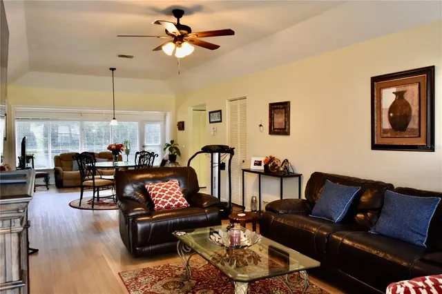 a living room with furniture a chandelier and a rug