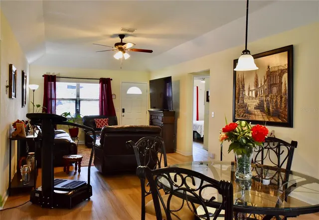 a view of a dining room with furniture and chandelier