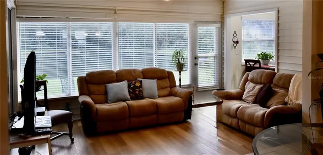 a living room with furniture and a large window