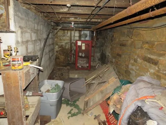 a view of a storage room with water heater and racks