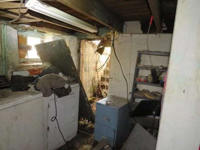 a room with water heater and car parked