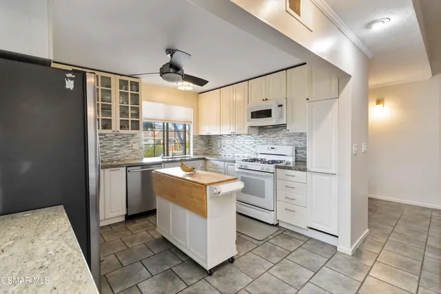 a kitchen with a stove a sink and a refrigerator
